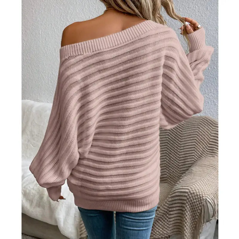 woman wearing a pink off-shoulder ribbed sweater styled with denim for a casual chic look